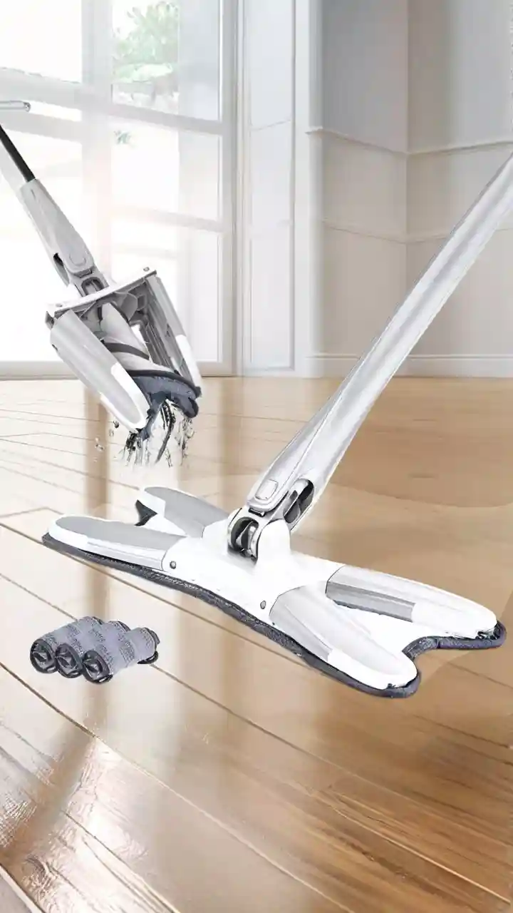 A person using a spinning mop system on a shiny wood floor, one of the best tools for effective home cleaning.